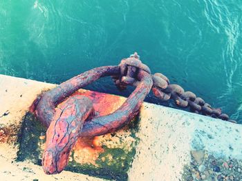 High angle view of rusty chain on sea