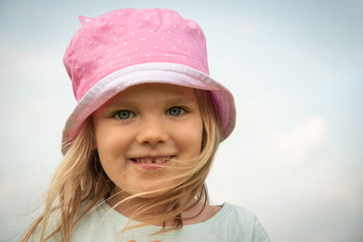 Portrait of smiling girl against sky