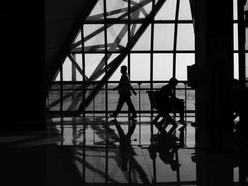 Silhouette people walking in airport