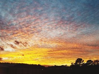 Low angle view of dramatic sky during sunset