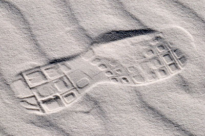 High angle view of shoe print on sand