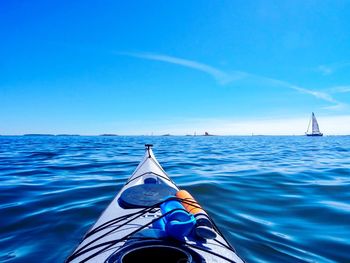 Sailboat sailing in sea against blue sky