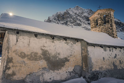 Low angle view of old building against sky during winter