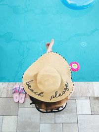 High angle view of man with hat on swimming pool