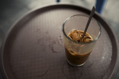 High angle view of coffee in glass on table
