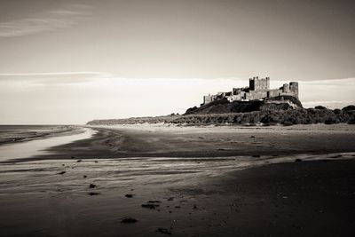 View of fort on beach against sky