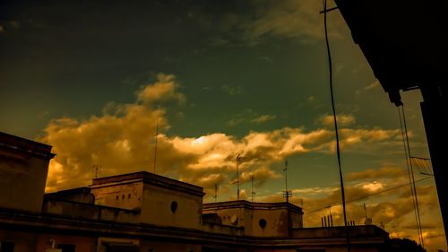 Low angle view of building against cloudy sky