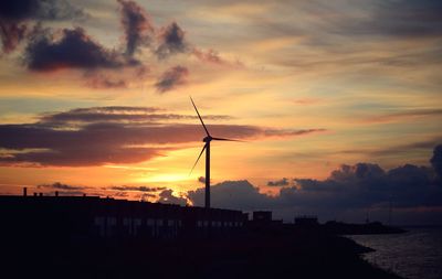 Silhouette of windmill at sunset