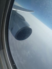 Close-up of airplane wing against sky