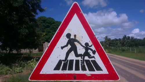 Road sign against trees