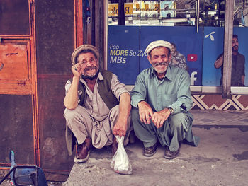 Portrait of two people sitting outdoors