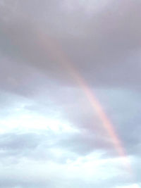 Low angle view of rainbow against sky