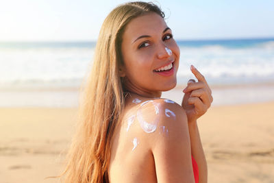 Portrait of smiling woman on beach