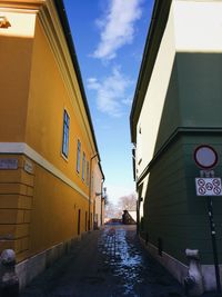 Road amidst buildings against sky in city