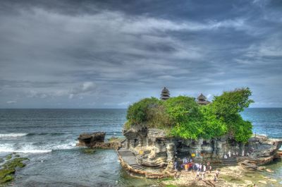 High angle view of tanah lot by sea against cloudy sky