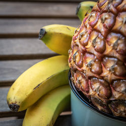 Close-up of bananas with pineapple on table
