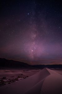 Scenic view of landscape against sky at night