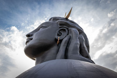 Low angle view of statue against cloudy sky