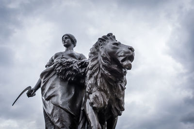 Low angle view of statue against cloudy sky