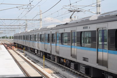 Train at railroad station against sky