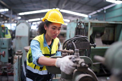 Side view of man working in factory