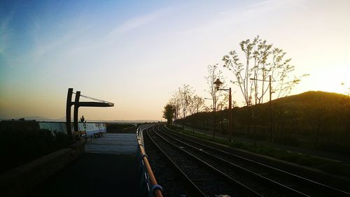 View of railroad tracks against sky during sunset