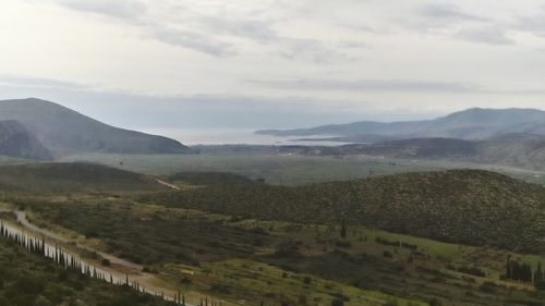 Scenic view of mountains against cloudy sky