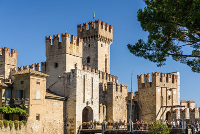 Low angle view of buildings against clear blue sky