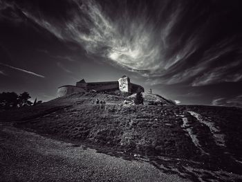 Built structure on beach against sky