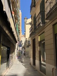 Narrow street amidst buildings in city