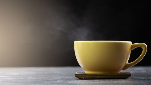 Close-up of coffee cup on table