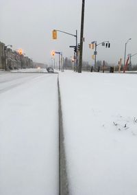 Snow covered road against sky