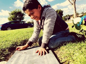 Midsection of man sitting on field