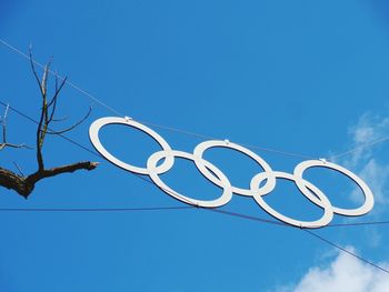 Low angle view of lighting equipment against clear blue sky