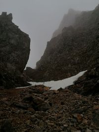 Rock formations on mountain against sky