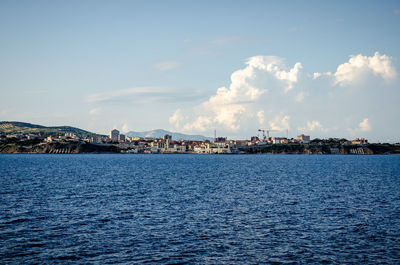 Panoramic view of sea and buildings against sky