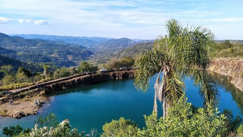 Scenic view of lake by trees against sky