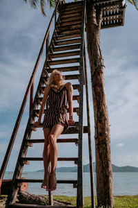 Low angle view of woman standing on staircase