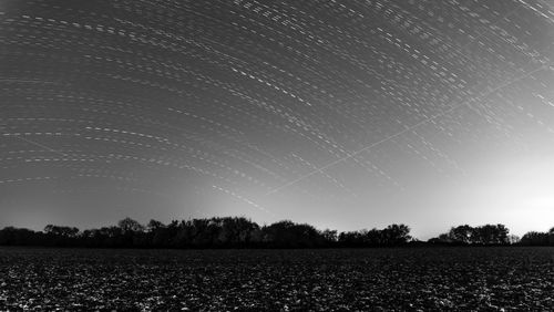 Scenic view of field against sky at night