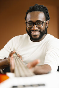 Portrait of man playing guitar