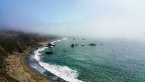 Aerial view. high above on the ocean cliffs. sweeping coastal beach.