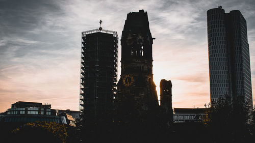 Low angle view of silhouette buildings against sky during sunset