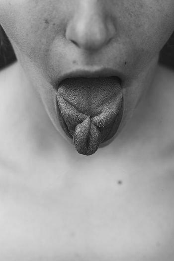 Midsection of woman showing tongue