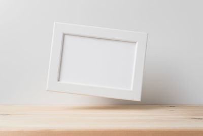 Close-up of white table against the wall