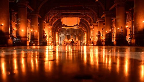 Reflection of illuminated building in water at night