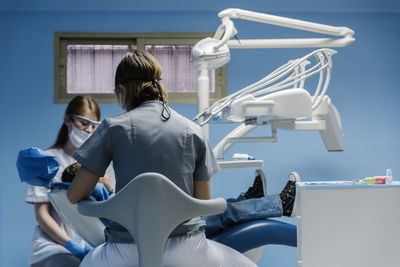 Dentists operating boy in medical clinic