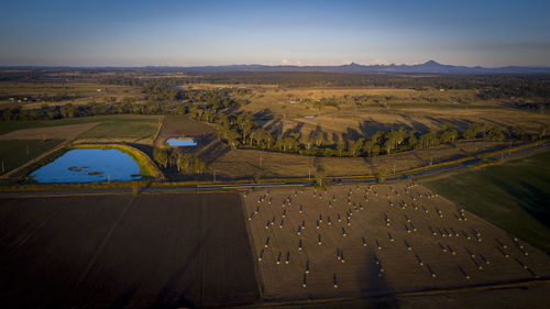 Aerial view of road amidst land against sky