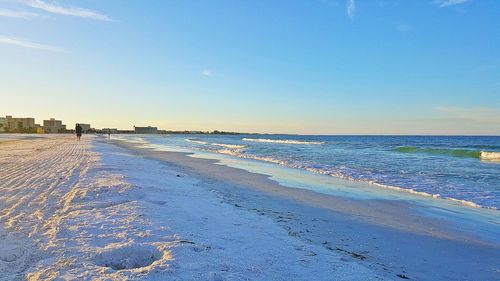 View of sand and beach against clear sky