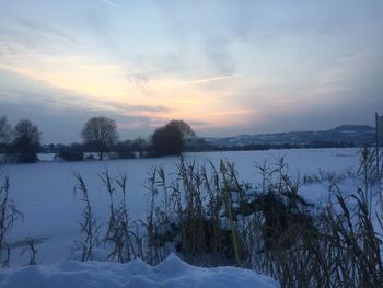 Scenic view of frozen lake against sky during winter