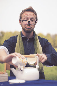 Portrait of smiling man standing with ice cream